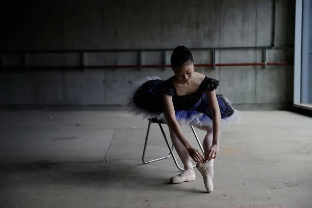 Moeno Oba, from Japan, a dancer from the Central School of Ballet holds a pose for photographers during a photocall in the unfinished interior of their new building on Paris Garden in the Southwark area of London, Tuesday, March 21, 2017. The school are undertaking a 6 million pound fundraising campaign to finish the building developments and are going on a five-month, 23 date tour around Britain from March 30 onwards. (Photo by Matt Dunham/AP Photo)