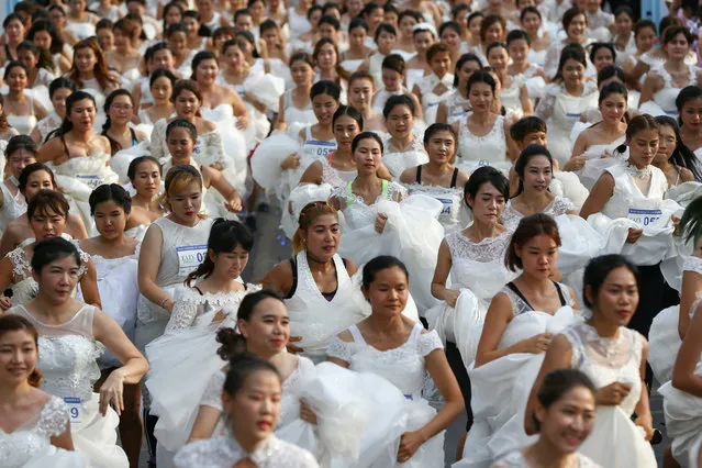 Brides-to-be participate in the “Running of the Brides” race in a park in Bangkok, Thailand March 25, 2017. (Photo by Athit Perawongmetha/Reuters)
