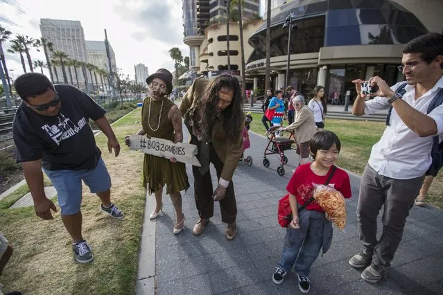 A couple dressed like zombies walks during the 2015 Comic-Con International Convention in San Diego, California July 9, 2015. (Photo by Mario Anzuoni/Reuters)