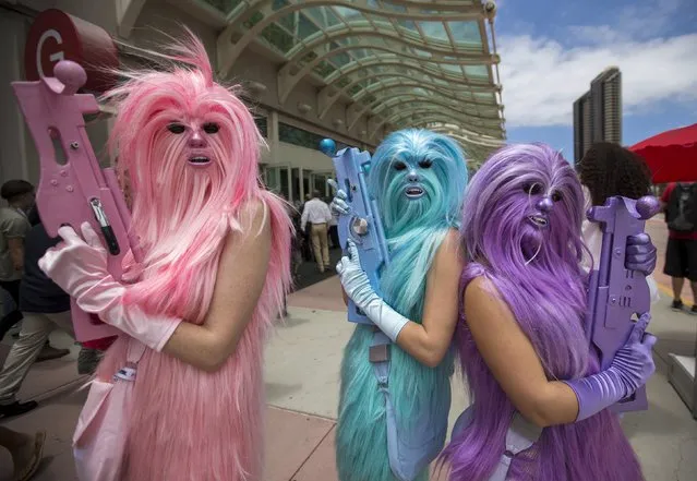 Star Wars enthusiasts wear costumes resembling what they say are three “Chew's Angels” during the 2015 Comic-Con International Convention in San Diego, California July 10, 2015. (Photo by Mario Anzuoni/Reuters)