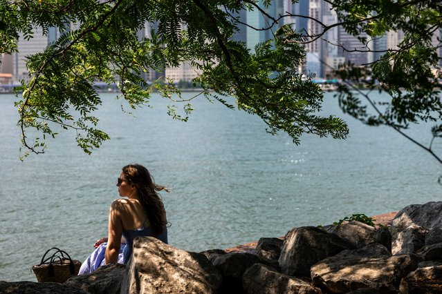 A woman pauses by the water in Brooklyn on a hot afternoon on July 09, 2024 in New York City. Thousands of New Yorkers are descending to area beaches, parks, pools, and cooling centers as the city experiences its second heat wave of the summer season. (Photo by Spencer Platt/Getty Images)