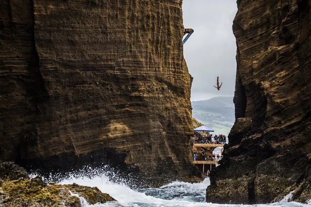 This handout photo received from Red Bull and taken on July 18, 2015 shows Jonathan Paredes of Mexico diving from the 27 metre platform during the fifth stop of the Red Bull Cliff Diving World Series at Islet Franco do Campo, Azores, Portugal. Gary Hunt of the UK won his fifth straight event of the year to take a commanding lead in the series. (Photo by Romina Amato/AFP Photo/Red Bull)