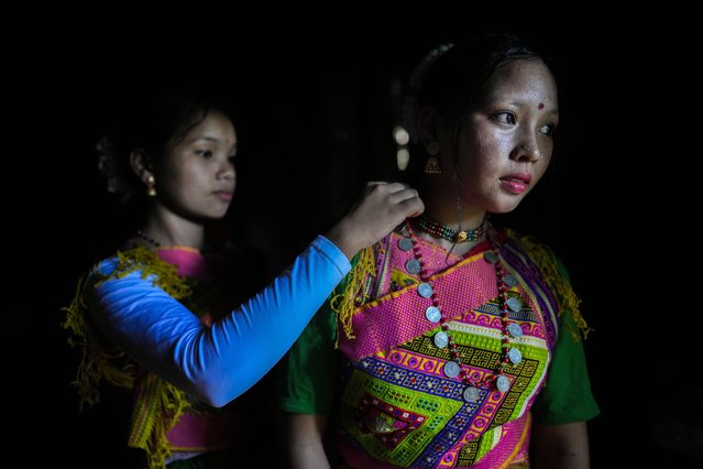 Tiwa tribal girls wear traditional attire before participating in Wanchuwa festival in a village in Karbi Angling district, India, Wednesday, July 24, 2024. Wanchuwa festival, marked once every five years, is celebrated for a good harvest and the welfare of the people. (Photo by Anupam Nath/AP Photo)