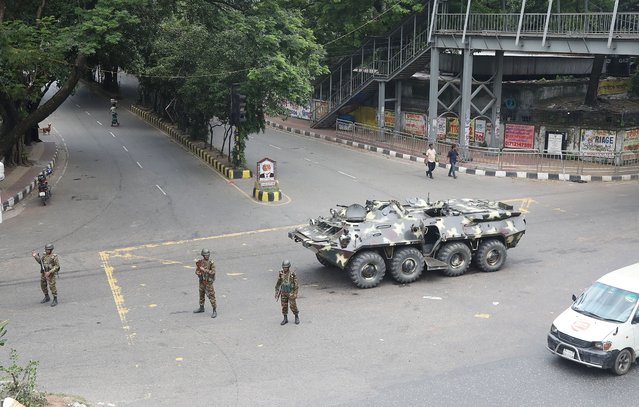 Bangladeshi soldiers stand guard on a street during curfew in Dhaka, Bangladesh, 21 July 2024. Police have been authorized to enforce 'shoot on sight' orders across the country during curfew. As casualties mounted and law enforcement struggled to contain the unrest, the Bangladeshi government imposed a nationwide curfew and deployed military forces after violence broke out in Dhaka and other regions following student-led protests demanding reforms to the government's job quota system. (Photo by Monirul Alam/EPA)