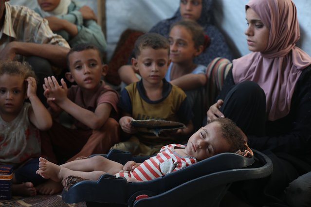 Palestinian infant Abdul Rahman Abu Al-Jidyan, 11 months, who contracted polio, receives care from his mother and family inside a tent in a shelter for displaced people west of El-Zawaida in central Gaza Strip, on August 27, 2024. The re-emergence of the polio virus in the Gaza Strip has sparked urgent concerns among health officials and aid organizations, with fears that tens of thousands of children could be at risk due to a crippled healthcare system and ongoing hostilities. (Photo by Naaman Omar/APAImages/Rex Features/Shutterstock)