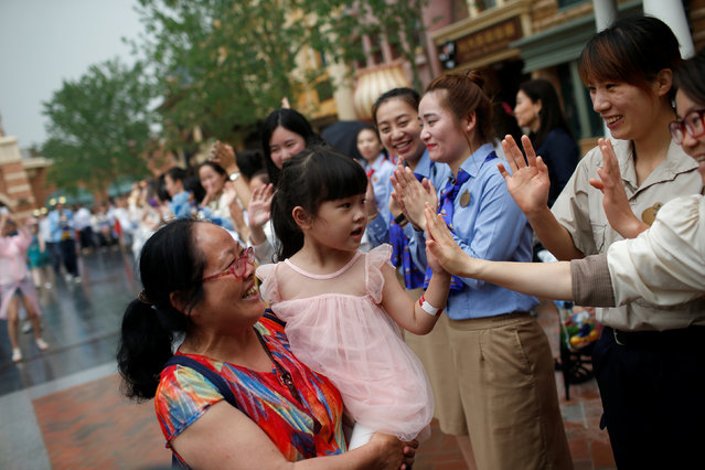 Staff welcome visitors coming after the opening ceremony of the Shanghai Disney Resort in Shanghai, China, June 16, 2016. (Photo by Aly Song/Reuters)