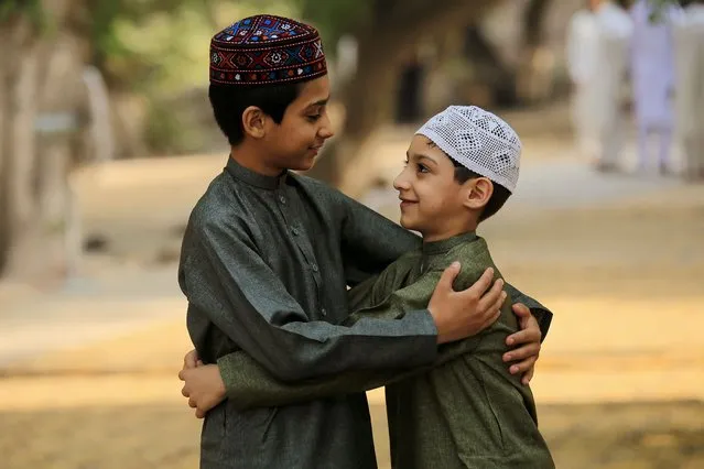 Children greet each other after Eid al-Fitr prayers in Peshawar, Pakistan, 02 May 2022. Muslims around the world celebrate Eid al-Fitr, the three days festival marking the end of Ramadan. Eid al-Fitr is one of the two major holidays in the Islamic calendar. (Photo by Bilawal Arbab/EPA/EFE)