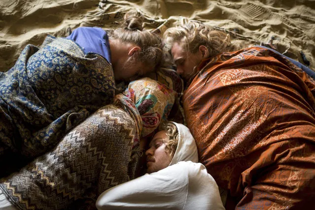 Young people sleep on the sand during the 12th O.Z.O.R.A. Festival, one of the largest psychedelic music festivals of Europe, near the village of Ozora, 123 kms south of Budapest, Hungary, 07 August 2015. The festival runs from 03 to 09 August 2015. (Photo by Balazs Mohai/EPA)