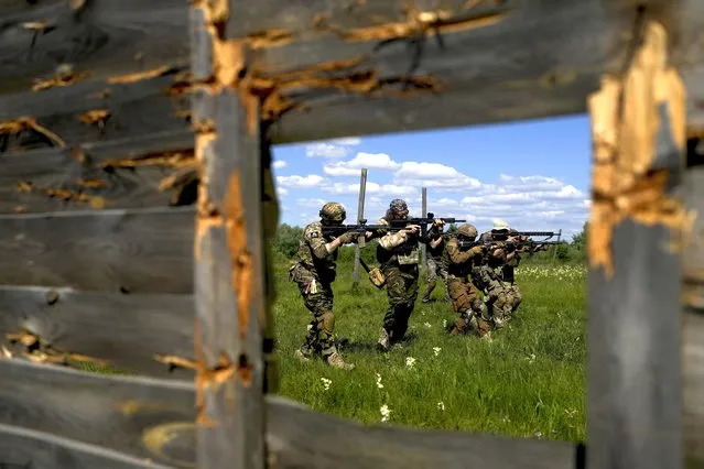 Civilian militia men hold shotguns during training at a shooting range in outskirts Kyiv, Ukraine, Tuesday, June 7, 2022. (Photo by Natacha Pisarenko/AP Photo)