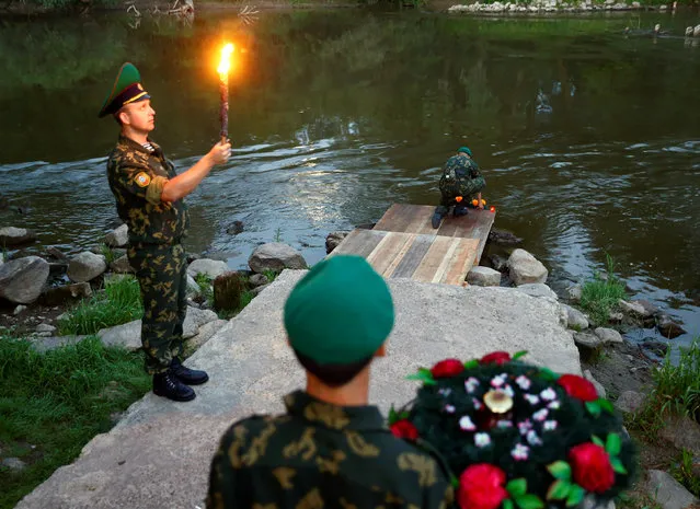 Belarussian border guards take part in a wreath laying ceremony at the memorial at Hero fortress as they mark the 75th anniversary of the Nazi Germany invasion, in Brest, Belarus June 22, 2016. (Photo by Vasily Fedosenko/Reuters)