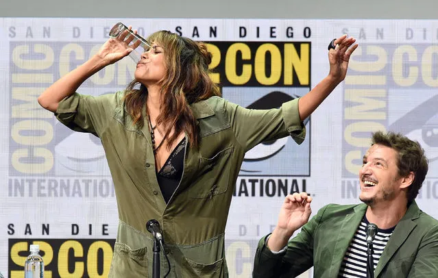 Actor Halle Berry (L) takes a drink onstage while actor Pedro Pascal looks on at the 20th Century FOX panel during Comic-Con International 2017 at San Diego Convention Center on July 20, 2017 in San Diego, California. (Photo by Kevin Winter/Getty Images)