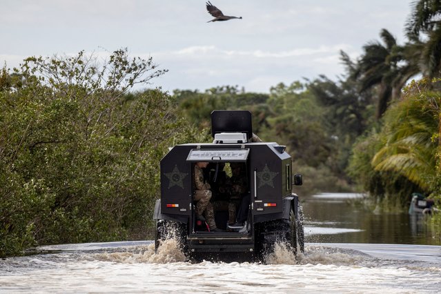 Lee County Sheriff deputies ride in an amphibious vehicle to look for residents stranded in flooded communities, after Hurricane Milton made landfall, in Iona, Florida, U.S., October 10, 2024. (Photo by Ricardo Arduengo/Reuters)