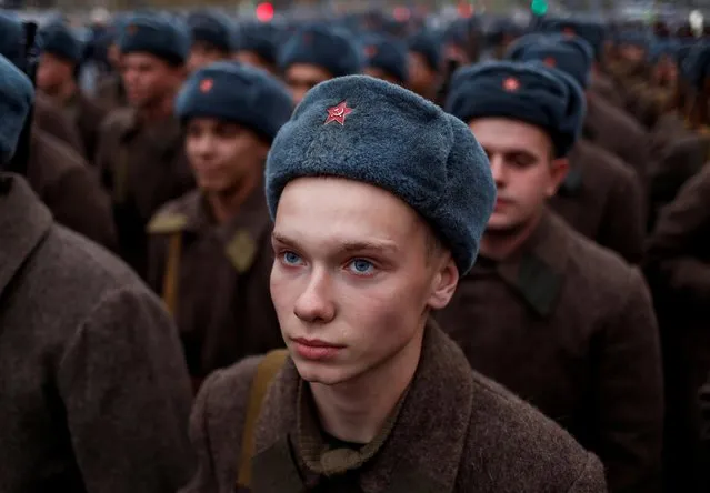A Russian Army member, dressed in historical uniform, looks on before a rehearsal for a military parade to mark the anniversary of a historical parade in 1941, when Soviet soldiers marched towards the front lines, at the Red Square in Moscow, Russia November 5, 2019. (Photo by Maxim Shemetov/Reuters)