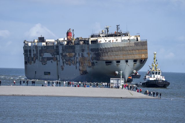 Stricken cargo ship Fremantle Highway, that caught fire while transporting thousands of cars, including nearly 500 electric vehicles, from Germany to Singapore, is towed into the port of Eemshaven, the Netherlands, on Thursday, August 3, 2023. The ship that burned for almost a week close to busy North Sea shipping lanes and a world renowned migratory bird habitat will be salvaged at the northern Dutch port. (Photo by Peter Dejong/AP Photo)