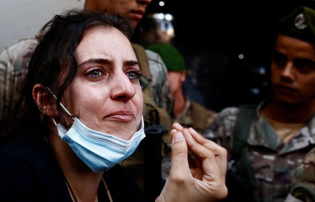 A woman reacts, as members of security forces attempt to evict displaced people from an old hotel, amid ongoing hostilities between Hezbollah and Israeli forces, in the Hamra neighbourhood of Beirut, Lebanon on October 21, 2024. (Photo by Yara Nardi/Reuters)