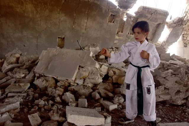 A 6-year-old Syrian girl, Nur Setut, born in 2011 when Syrian civil war began, exercises karate with her own means in Aleppo, Syria on August 09, 2017. Despite all difficulties, her father and mother who are trainers, train their girl to realize her dreams of becoming a world karate champion. (Photo by Yehya Alrejjo/Anadolu Agency/Getty Images)