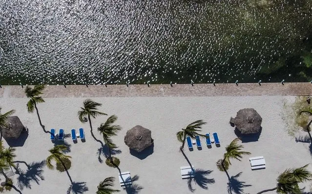 An aerial view shows a deserted beach resort in Windley Key, some 70 miles south of Miami, on March 22, 2020, during the coronavirus (COVID-19) outbreak. The Florida Keys have closed down to visitors. Heavily relying on tourism, at the peak of high season, Florida's most southern holiday islands have been forced to shut down hotels amid the COVID-19 pandemic. (Photo by Chandan Khanna/AFP Photo)