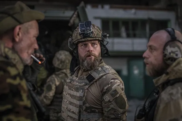 Ukrainian soldiers talk during heavy fighting at the front line in Severodonetsk, Luhansk region, Ukraine, Wednesday, June 8, 2022. (Photo by Oleksandr Ratushniak/AP Photo)
