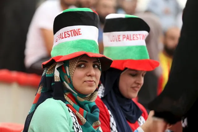 Fans of Palestine watch the 2018 World Cup qualifying soccer match against the United Arab Emirates, at Faisal al-Husseini Stadium, in the occupied West Bank town of Al-Ram near Jerusalem September 8, 2015. (Photo by Mohamed Torokman/Reuters)