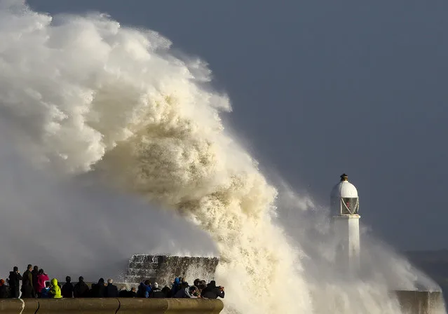 Huge waves strike the harbour wall and lighthouse at Porthcawl, south Wales, on October 16, 2017 as Storm Ophelia hits the UK and Ireland. Ireland was hit by an “unprecedented storm” on Monday that left two people dead, 120,000 homes and businesses without power and closed every school in the country. The storm also sent strong winds over the southwest of England and the south and west of Wales. (Photo by Geoff Caddick/AFP Photo)