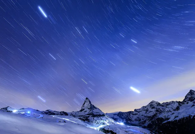 A long exposure of the starry sky over the Matterhorn mountain, seen from the Riffelberg area, in Zermatt, Switzerland, 14 April 2015. On the 14th of July, Zermatt celebrates 150 years since the first ascent of the Matterhorn mountain. On 14 July 1865, British climber Edward Whymper reached the peak of the Matterhorn (4,478 metres above sea level) together with his rope team. (Photo by Jean-Christophe Bott/EPA)