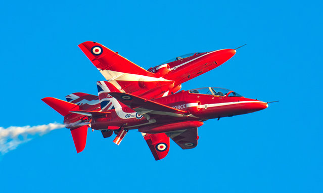 The picture dated January 15, 2025 shows the Red Arrows making the most of the fine weather to train over RAF Waddington in Lincolnshire, UK. The team left vapour trails, which were illuminated by the sunlight, as they rehearsed in the skies and practised their signature moves. They train in the UK until mid-Spring when they move overseas to a location with more predictable, settled weather to maximise flying hours. (Photo by Claire Hartley/Bav Media)