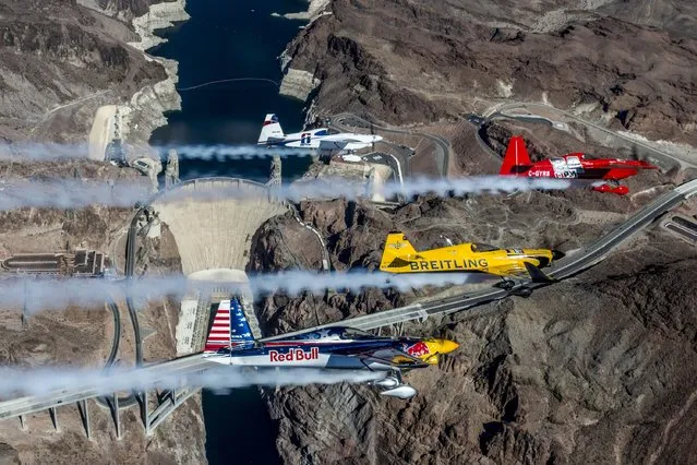 Pete McLeod of Canada flies in formation with Nigel Lamb of Great Britain, Martin Sonka of the Czech Republic and Kirby Chambliss of the United States during a Recon flight prior to the seventh stage of the Red Bull Air Race World Championship over the Hoover Dam on October 09, 2014 on the border between the U.S. states of Arizona and Nevada. (Photo by Joerg Mitter/Red Bull via Getty Images)