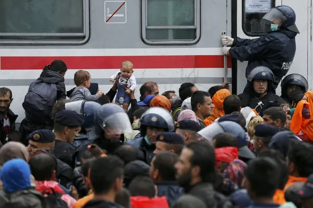 Migrants with babies wait to board a train at the station in Tovarnik, Croatia, September 20, 2015. (Photo by Antonio Bronic/Reuters)