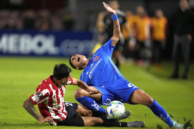 Matias Sepulveda of Chile's Universidad de Chile, right, falls as he is tackled by Eric Meza of Argentina's Estudiantes de La Plata during a Copa Libertadores Group A soccer match at Jorge Luis Hirschi stadium in La Plata, Argentina, Tuesday, April 8, 2025. (Photo by Gustavo Garello/AP Photo)