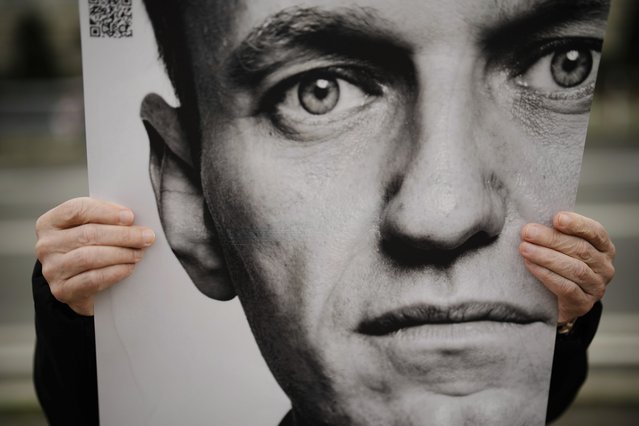 A man holds a poster with a portrait of opposition leader Alexei Navalny during a protest in front of the Russian embassy in Berlin, Germany, Friday, February 16, 2024. Navalny, who crusaded against official corruption and staged massive anti-Kremlin protests as President Vladimir Putin’s fiercest foe, died Friday in the Arctic penal colony where he was serving a 19-year sentence, Russia’s prison agency said. He was 47. (Photo by Markus Schreiber/AP Photo)