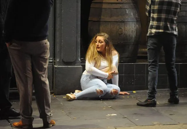 Revellers out and about in Newcastle, England on “Black Eye Friday” or “Mad Friday” on December 22, 2017. This partygoer had so much fun she looks lost. (Photo by Craig Connor/North News and Pictures)