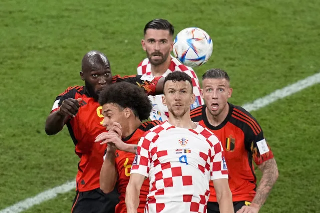 Croatia's Ivan Perisic (4) goes up for the ball against Belgium's Romelu Lukaku, left, Axel Witsel, bottom left, and Toby Alderweireld, right, during the World Cup group F soccer match between Croatia and Belgium at the Ahmad Bin Ali Stadium in Al Rayyan, Qatar, Thursday, December 1, 2022. Croatia's Marko Livaja, back, looks on. (Photo by Ebrahim Noroozi/AP Photo)