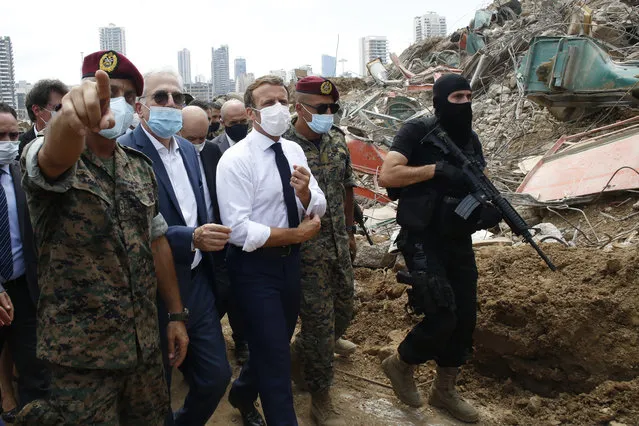 French President Emmanuel Macron, center, visits the devastated site of the explosion at the port of Beirut, Lebanon, Thursday August 6, 2020. French President Emmanuel Macron has arrived in Beirut to offer French support to Lebanon after the deadly port blast. (Photo by Thibault Camus/AP Photo/Pool)