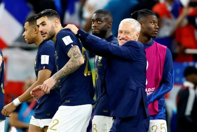 France's coach #00 Didier Deschamps (C-R) congratulates France's defender #22 Theo Hernandez after the Qatar 2022 World Cup round of 16 football match between France and Poland at the Al-Thumama Stadium in Doha on December 4, 2022. (Photo by Suhaib Salem/Reuters)