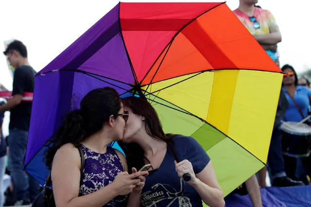 A gay couple kisses each other as thousands of catholics and conservatives gather together against the legalization of gay marriage and to defend their interpretation of traditional family values in Monterrey City, Mexico September 10, 2016. (Photo by Daniel Becerril/Reuters)