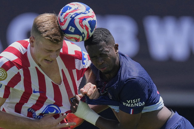 Atletico Madrid's Alexander Sorloth, left, goes for a header with Paris Saint-Germain's Willian Pacho during the Club World Cup group B soccer match between PSG and Atletico Madrid, in Pasadena, Calif., Sunday, June 15, 2025. (Photo by Mark J. Terrill/AP Photo)