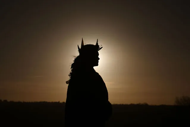 A young woman watches the sun come up as people gather to witness the winter solstice on December 21, 2022 in Newgrange, Ireland. Crowds are gathering at Newgrange in Co Meath, this morning for the winter solstice - the astronomical phenomenon that marks the shortest day and the longest night of the year. Newgrange is a Stone Age (Neolithic) monument in the Boyne Valley, County Meath, it is the jewel in the crown of Ireland's Ancient East and was constructed approximately 5,200 years ago (3,200 B.C.) which makes it older than Stonehenge and the Great Pyramids of Giza. (Photo by Charles McQuillan/Getty Images)