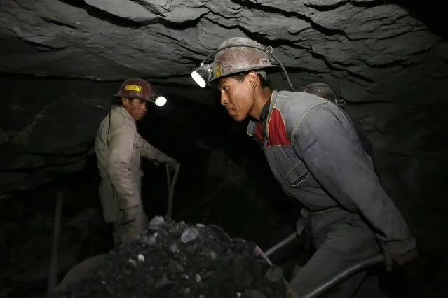 A mine worker carries minerals at “The Progreso” gold mine near La Paz November 13, 2014. (Photo by David Mercado/Reuters)