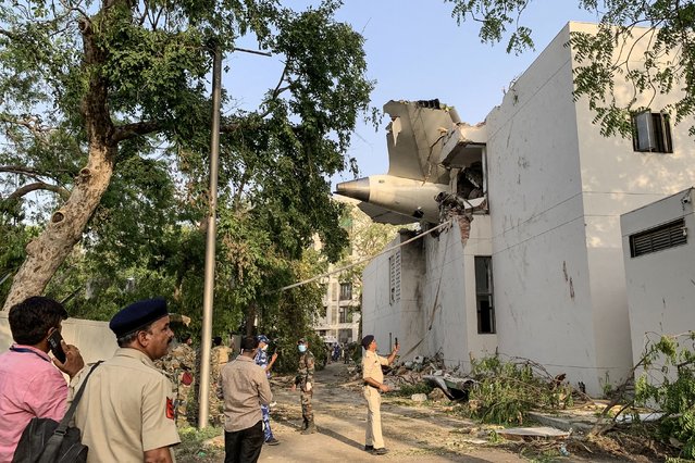 The back of Air India flight 171 is pictured at the site after it crashed in a residential area near the airport in Ahmedabad on June 12, 2025. A London-bound passenger plane crashed in the Indian city of Ahmedabad on June 12 and all 242 people on board were believed killed, with the jet smashing into buildings housing doctors and their families. (Photo by Sam Panthaky/AFP Photo)