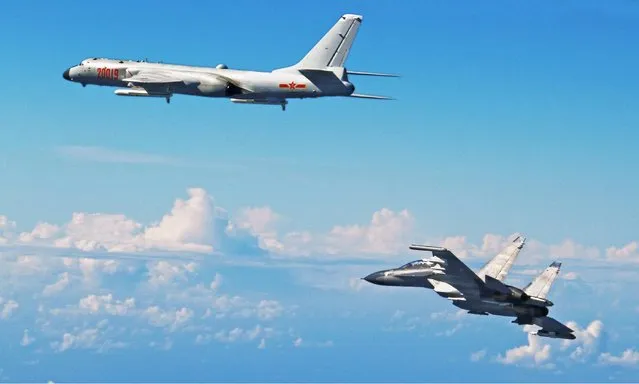 Chinese air force planes, including an H-6K bomber (left) and an Su-30 fighter, fly toward the Western Pacific over the Miyako Strait in Okinawa Prefecture on Sunday, September 25, 2016. The Air Self-Defense Force scrambled aircraft on Sunday as at least eight Chinese fighters and bombers – and possibly more than 40 – passed through a critical international entryway into the Western Pacific. They used a legal but politically sensitive passage through Okinawa, apparently to send a message to Tokyo. It was the first time Beijing is known to have sent fighter jets through the area, and comes days after Japan’s defense minister announced plans to step up engagement in the disputed South China Sea. The Chinese aircraft, which also included refueling tankers, flew over the Miyako Strait in Okinawa Prefecture but did not infringe Japanese airspace, the Defense Ministry said in Tokyo. (Photo by CNS/Kyodo News)