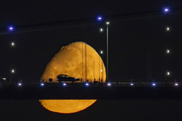 The moon is seen above vehicles crossing the July 15 Martyrs Bridge in Istanbul, Turkiye, on July 6, 2025. (Photo by Isa Terli/Anadolu via Getty Images)