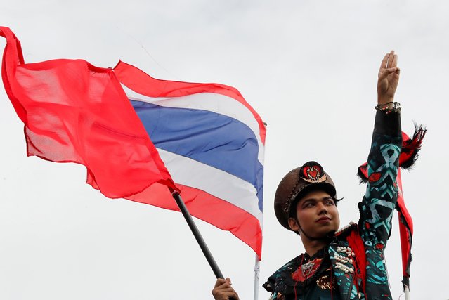 A pro-democracy protester flashes the three-fingers salute as he attends a mass rally to call for the ouster of prime minister Prayuth Chan-ocha's government and reforms in the monarchy, in Bangkok, Thailand, September 19, 2020. (Photo by Jorge Silva/Reuters)