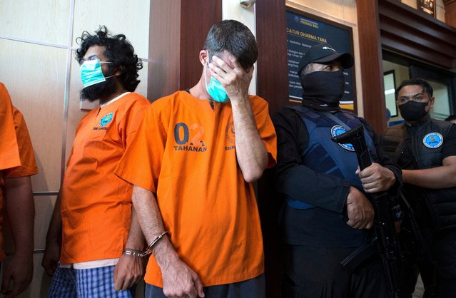Australian national identified as P.R., second left, and an Indian national identified as H.V., left, who were arrested for drug possession, react during a National Narcotics Agency press conference in Denpasar, Bali, Indonesia Thursday, June 5, 2025. (Photo by Firdia Lisnawati/AP Photo)