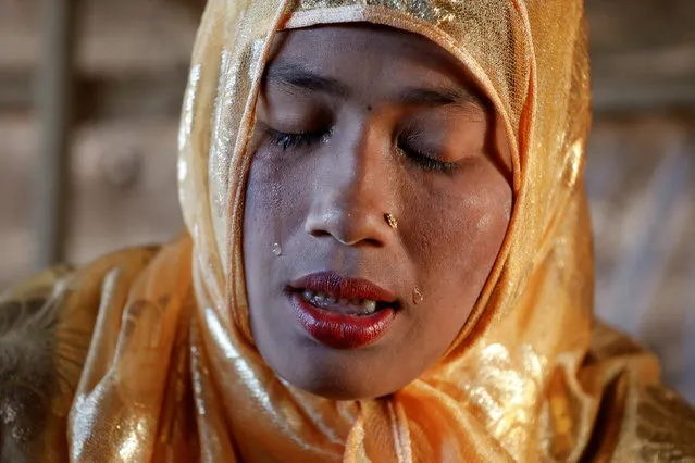 Rahima cries, after the body of her nephew, an 11-month-old Rohingya refugee Abdul Aziz was brought back to the family shelter at the Balukhali refugee camp near Cox's Bazar, Bangladesh, a few hours after he died December 4, 2017. Aziz, whose family fled Myanmar some two months ago, died at a local clinic after suffering from high fever and severe cough for ten days, his mother said. (Photo by Damir Sagolj/Reuters)