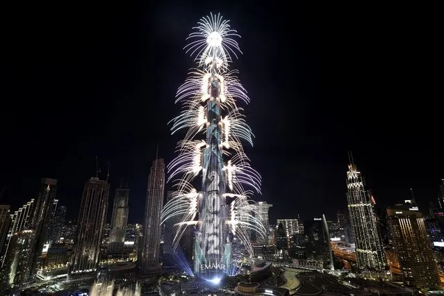 Fireworks explode from the Burj Khalifa, the world's tallest building, during the New Year's Eve celebration in Dubai, United Arab Emirates, Saturday, January 1, 2022. (Photo by Kamran Jebreili/AP Photo)