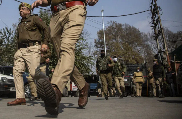 Indian police chase activists of Peoples Democratic party (PDP) protesting against India's new land laws that allows any Indian citizen to buy land in the disputed region in Srinagar, Indian controlled Kashmir, Thursday, October 29, 2020. Until last year, Indians were not allowed to buy property in the region. But in August 2019, Prime Minister Narendra Modi’s government scrapped the disputed region’s special status, annulled its separate constitution, split the region into two federal territories. (Photo by Mukhtar Khan/AP Photo)