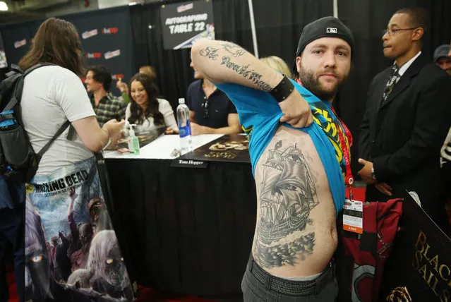 A fan shows off his tattoo during an autograph signing for the STARZ Original Series “Black Sails” at New York Comic Con on Friday, October 7, 2016 in New York. (Photo by Matt Sayles/Invision for STARZ/AP Images)