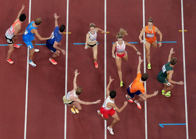 Netherlands' Lieke Klaver, Poland's Natalia Bukowiecka and Belgium's Imke Vervaet in action as they pass their batons in the Mixed's 4 x 400m Relay Final on September 13, 2025. (Photo by Fabrizio Bensch/Reuters)