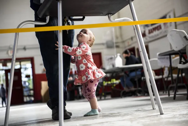Sabrina Jackson waits while her dad Jack Jackson fills out a ballot at the St. Paul's National Guard Armory on Election Day on November 3, 2020 in St. Pauls, North Carolina.  After a record-breaking early voting turnout, Americans head to the polls on the last day to cast their vote for incumbent U.S. President Donald Trump or Democratic nominee Joe Biden in the 2020 presidential election. (Photo by Melissa Sue Gerrits/Getty Images)