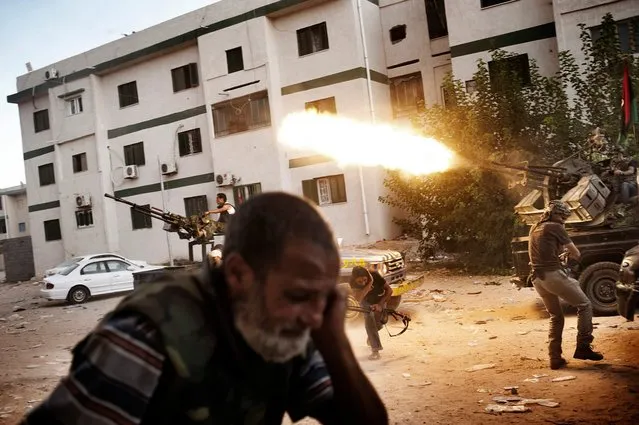 Libyan rebels clash with Gaddafi loyalists in Tripoli’s Abu Slim neighborhood in August 2011. (Photo by Yuri Kozyrev/Noor Photo)